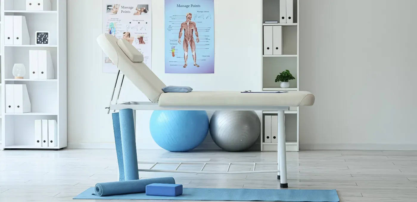 Treatment room at TheraCure clinic with therapy table, exercise balls and mats