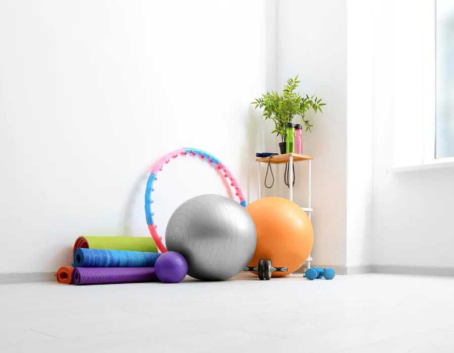 Clear, well-lit home space with exercise equipment prepared for an online physiotherapy consultation