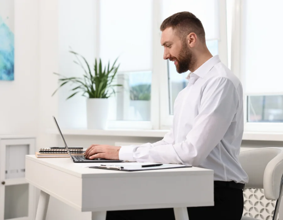 Man working with upright, well-aligned posture at a standing desk