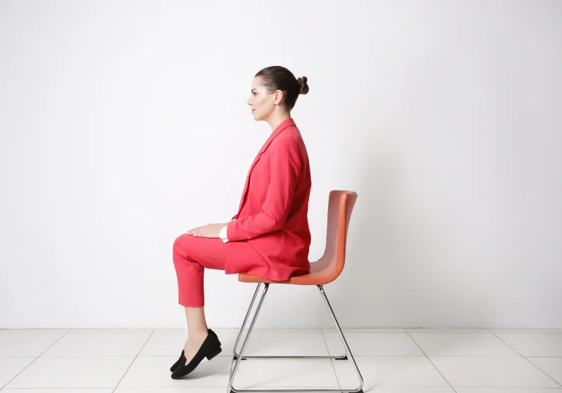 Correct upright sitting posture assessed during a home ergonomics visit